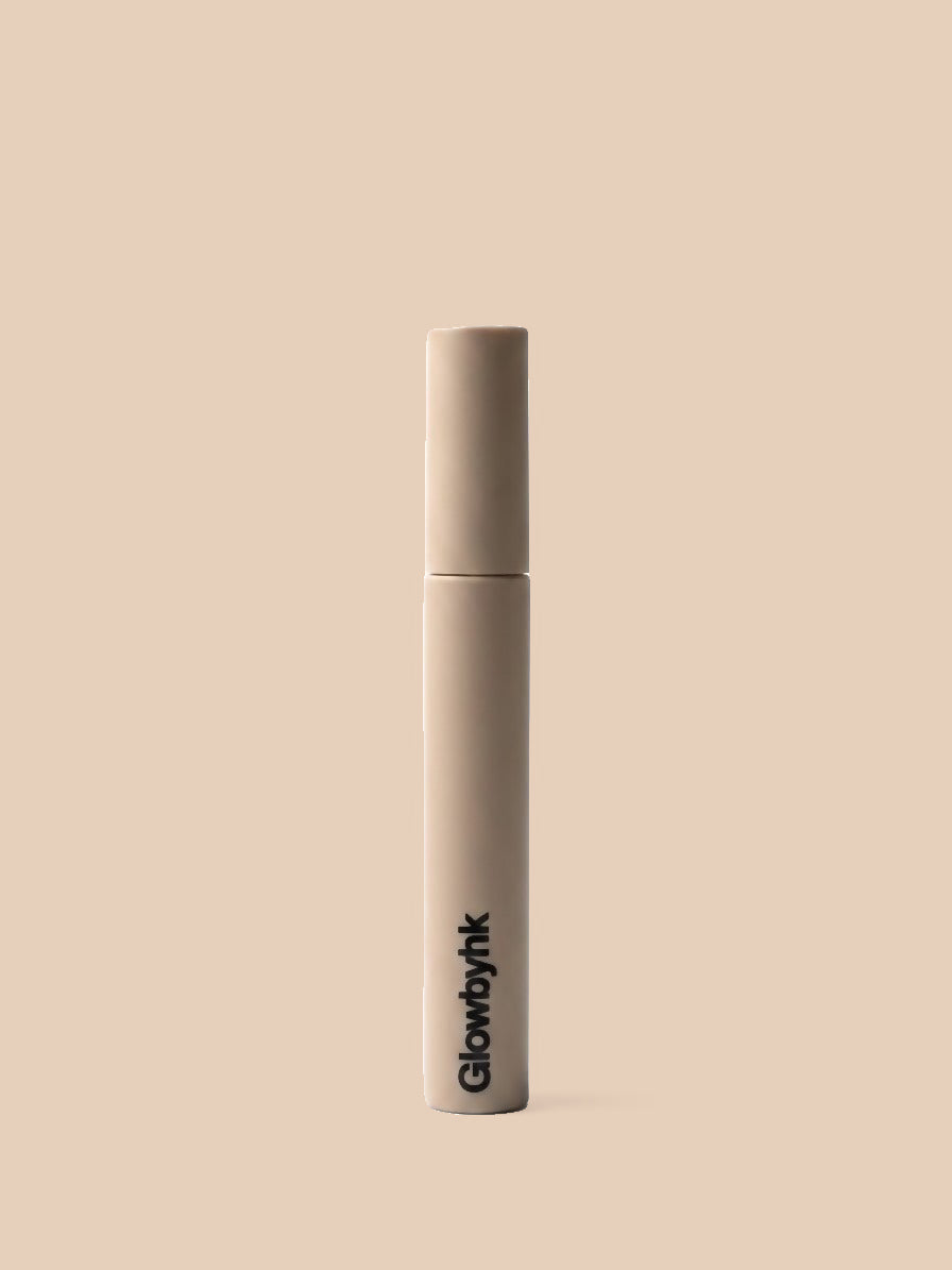 GlowbyHK Brow Gel on warm beige background