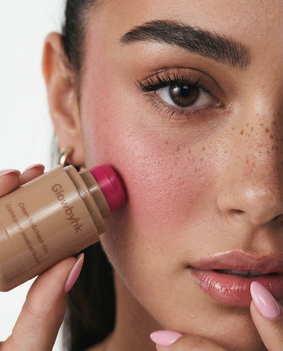 Model applying GlowbyHK Cream Blush