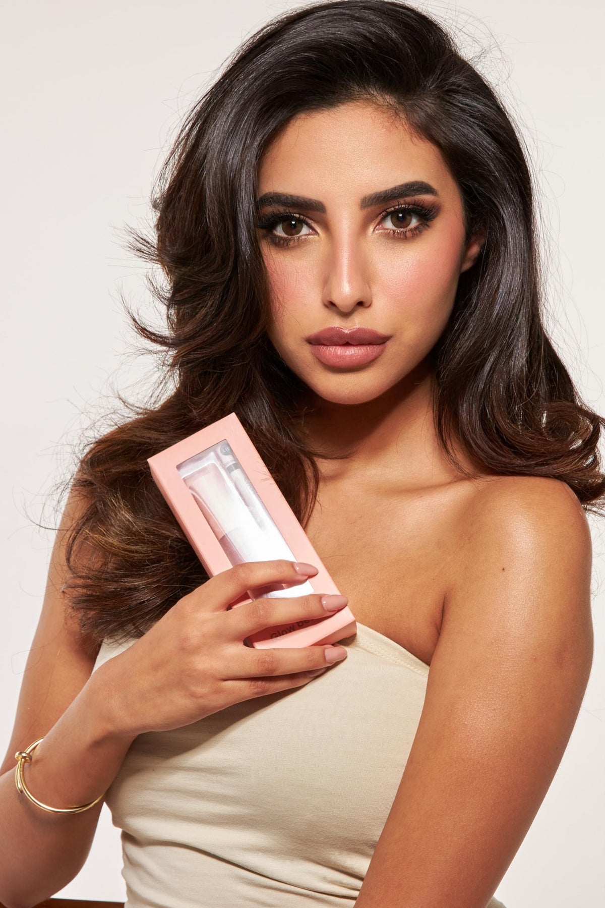 GlowbyHK model holding a Lip Kit