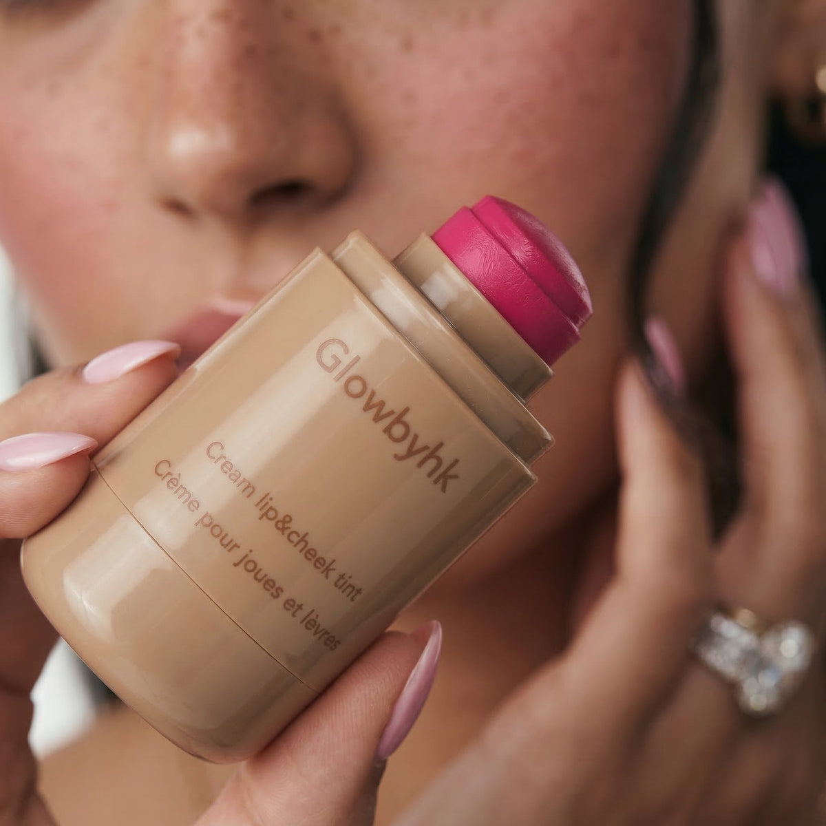 Model holding Pink Tan Cream Blush