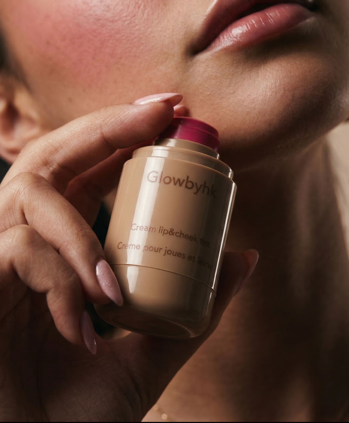 Model holding Pink Tan Cream Blush